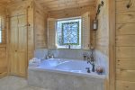 Main floor bathroom offers a soaker tub, a double vanity and a large tile shower